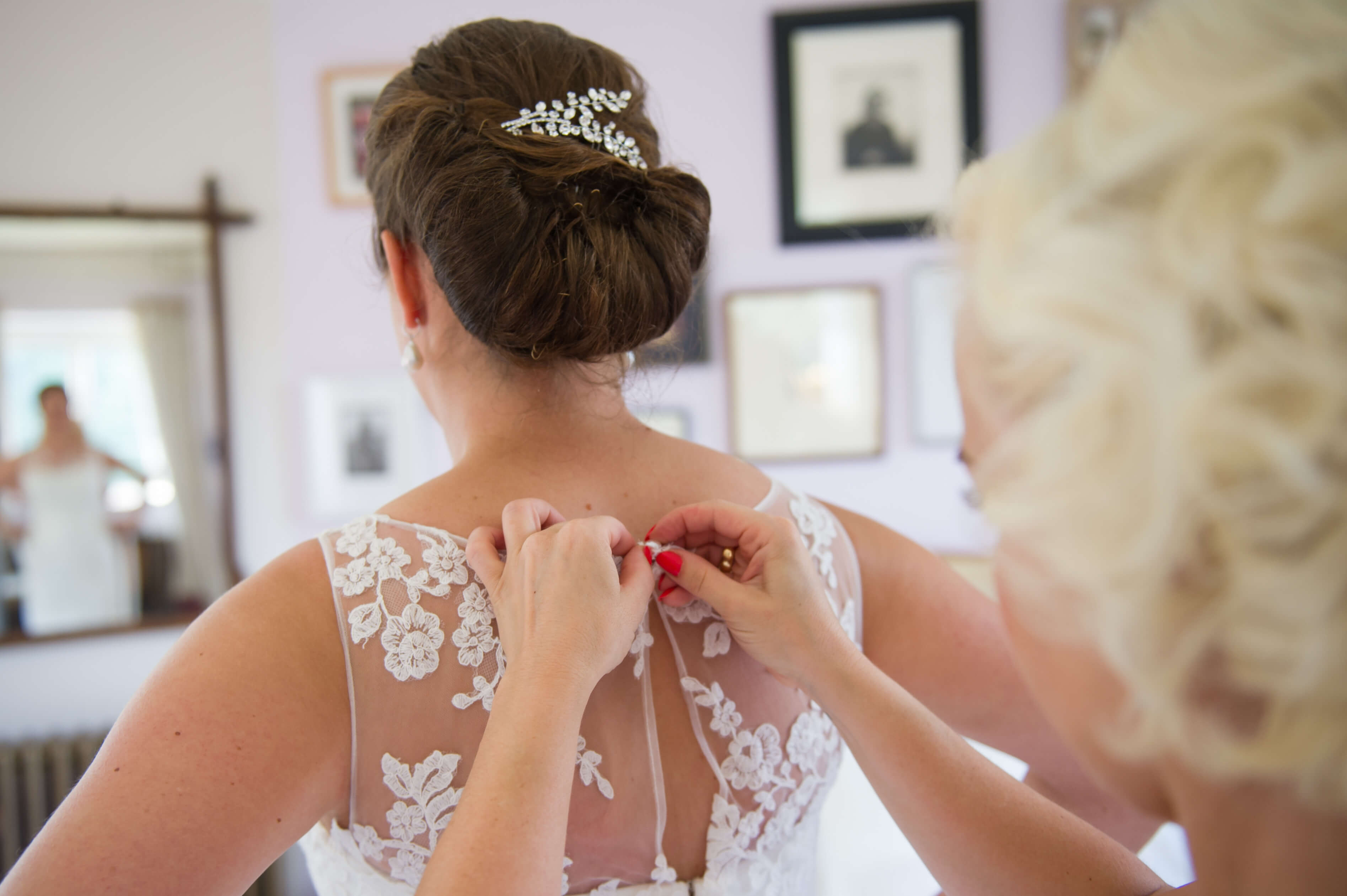 Bride putting on her wedding dress at voewood